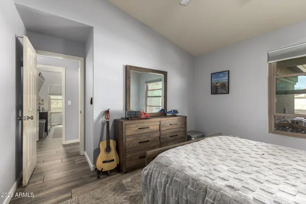 a bedroom with a bed and wooden floor