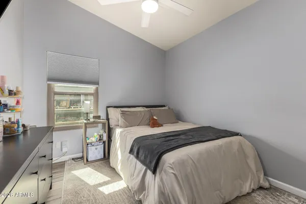 a bedroom with a bed and a chandelier