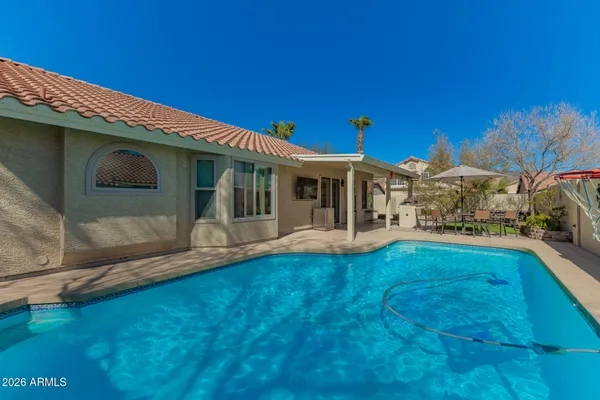 a view of house with swimming pool outdoor seating