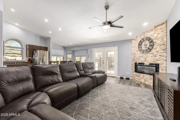 a living room with furniture a flat screen tv and a fireplace