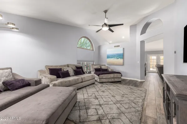 a living room with furniture and a chandelier