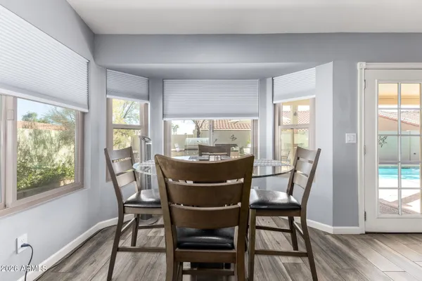 a view of a dining room with furniture window and wooden floor