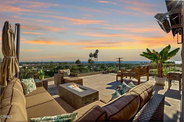 a view of a terrace with couches and lounge chairs