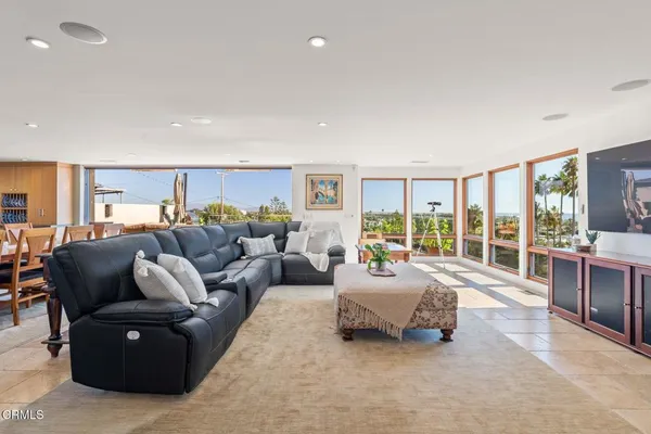 a living room with furniture fireplace and flat screen tv