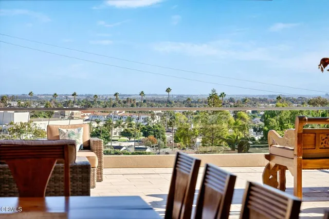 a kitchen with stainless steel appliances granite countertop a sink a counter top space and living room view