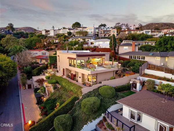 an aerial view of multiple houses with yard