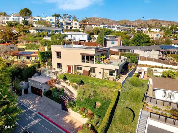 an aerial view of a house with a swimming pool outdoor seating and yard