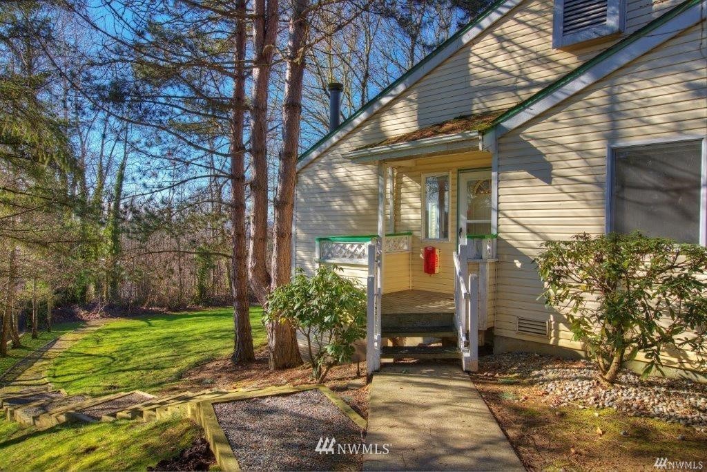 833 Southwest Sunset Boulevard, Unit E22 Renton, WA 98057 - Photo 1 of 18 a view of a house with a yard