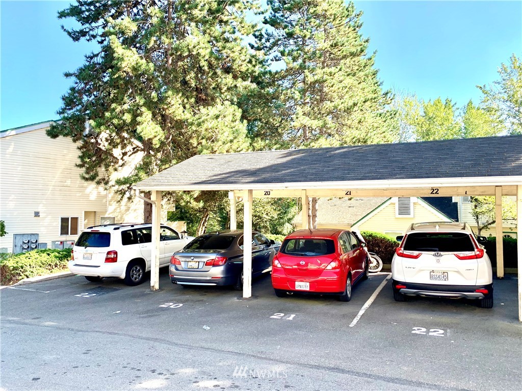 833 Southwest Sunset Boulevard, Unit E22 Renton, WA 98057 - Photo 17 of 18 a view of cars parked in a parking lot