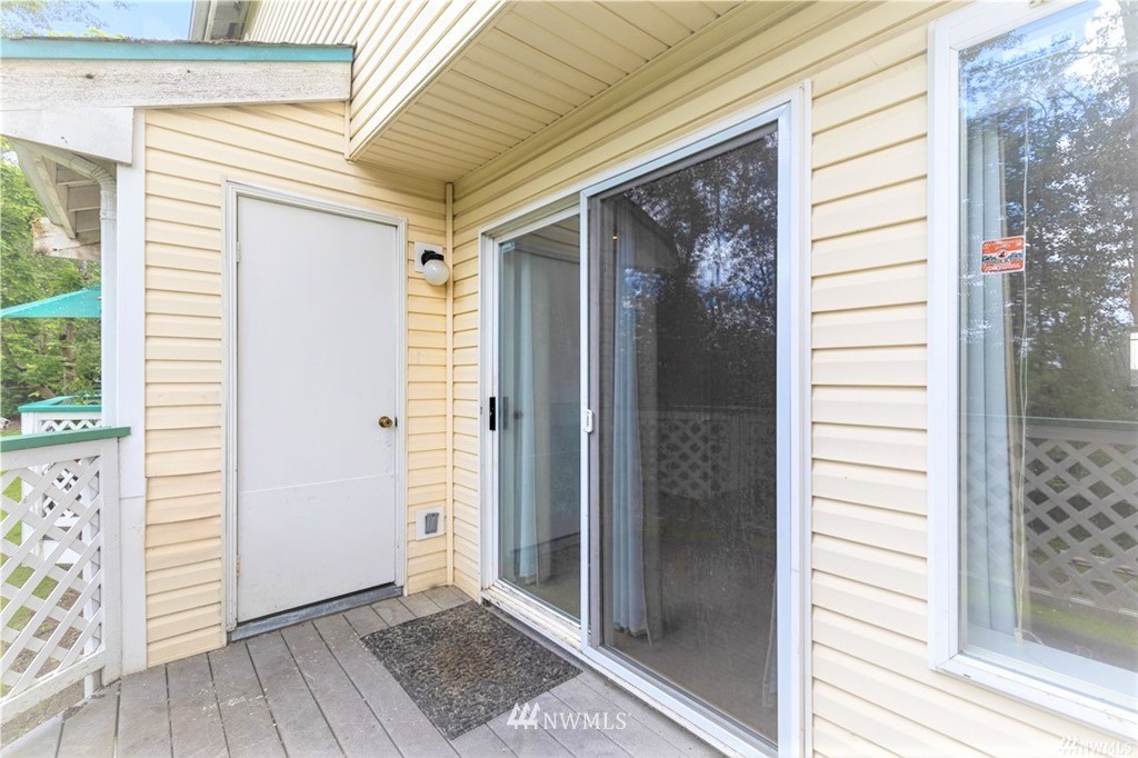 833 Southwest Sunset Boulevard, Unit E22 Renton, WA 98057 - Photo 6 of 18 a view of a front door and wooden floor