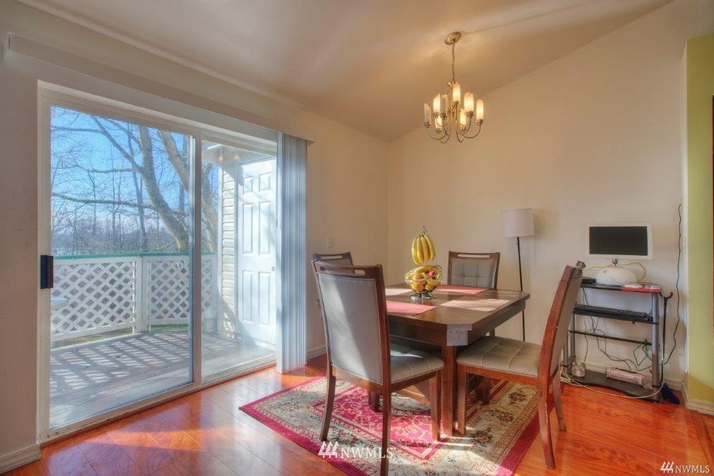 833 Southwest Sunset Boulevard, Unit E22 Renton, WA 98057 - Photo 7 of 18 a view of a dining room with furniture and wooden floor