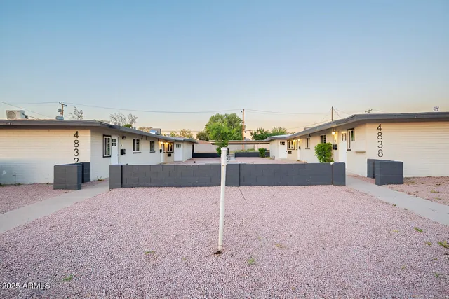 a view of a house with a backyard and a tree