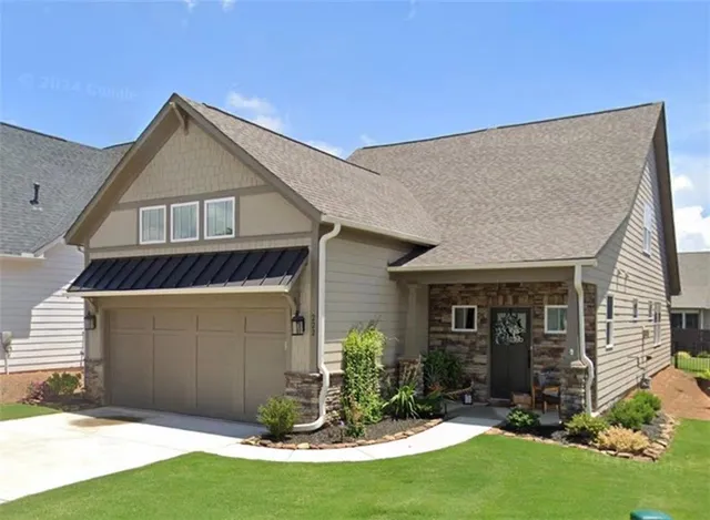 a front view of a house with a yard and garage