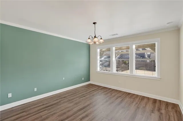a view of cabinets and utility room with racks on the wall