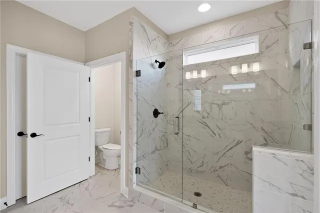 a bathroom with a granite countertop sink and a bathtub