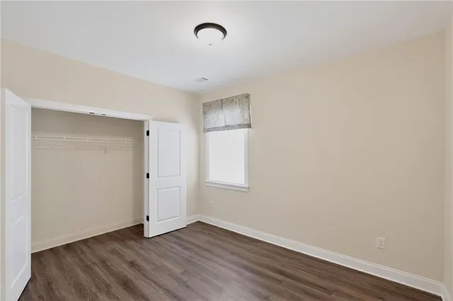 a bathroom with a granite countertop bathtub shower sink vanity and toilet