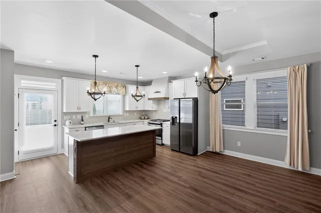 a view of a room with wooden floor and chandelier