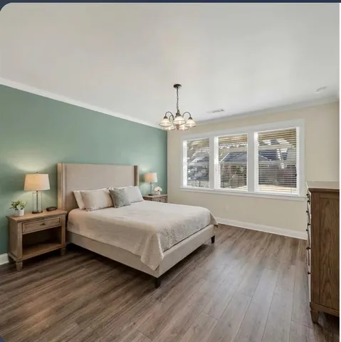 a view of a livingroom with wooden floor fireplace and a window