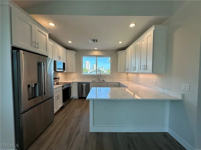 a kitchen with sink cabinets and window