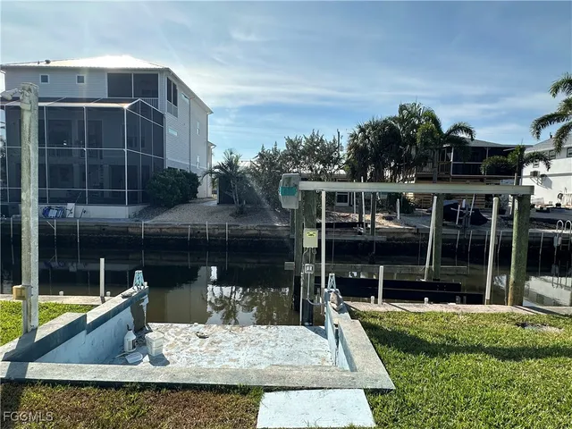 a view of house with a yard and sitting area
