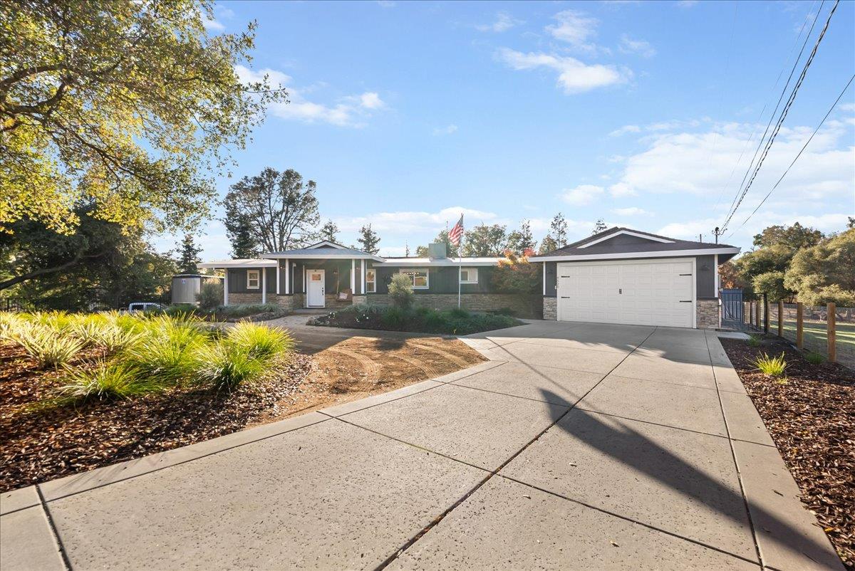 a front view of a house with garden