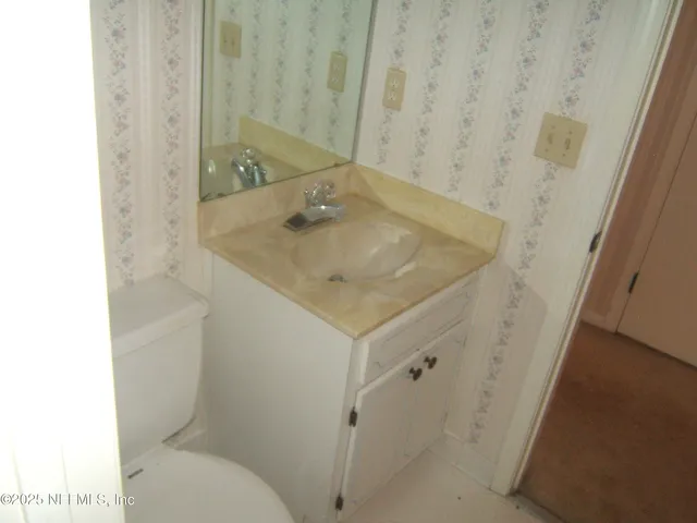 a bathroom with a sink and toilet