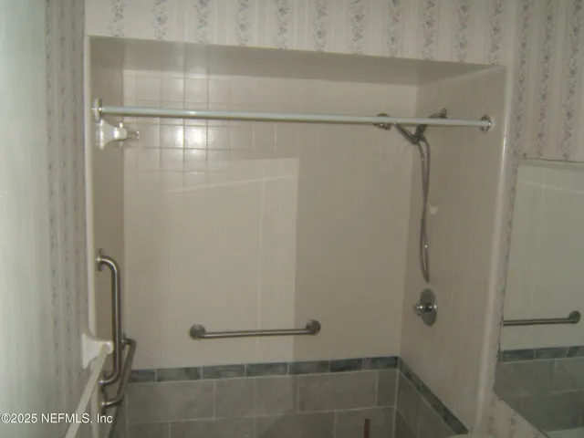 a bathroom with a glass shower door