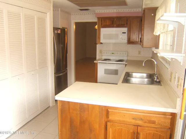 a kitchen with a refrigerator sink and stove