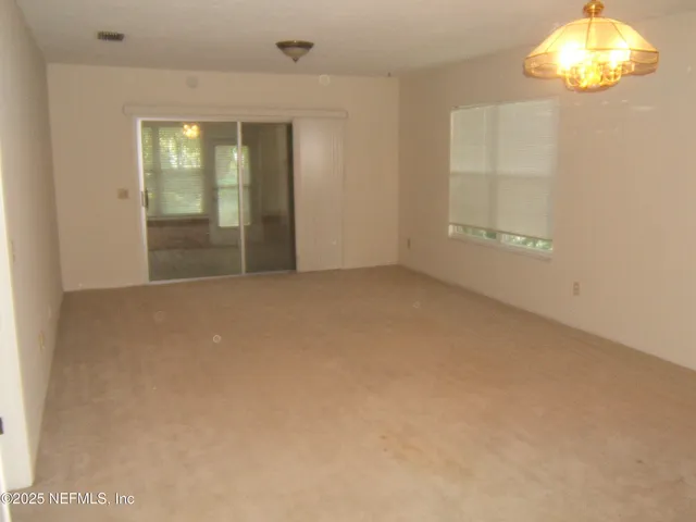 an empty room with windows and entrance