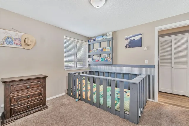 a view of a bedroom with furniture
