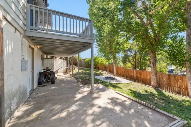 a view of a porch with wooden stairs and a fence