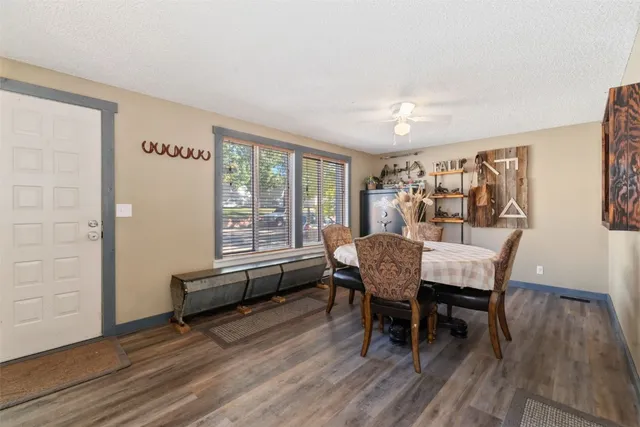 a dining room with furniture and wooden floor