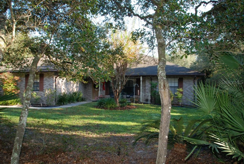 3515 Sandy Ridge Trail DeLand, FL 32724 - Photo 1 of 1 a front view of a house with garden