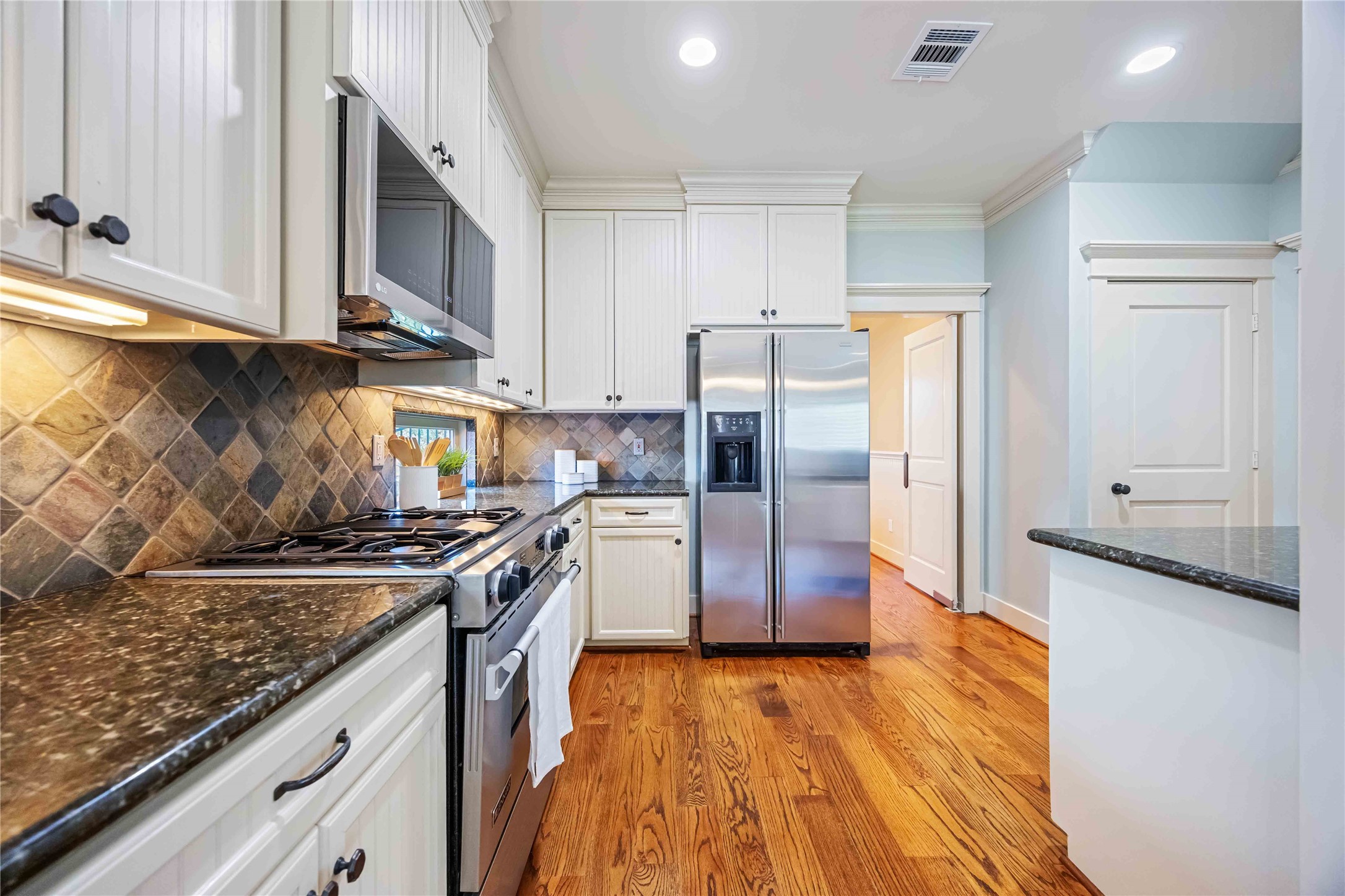 3541 Michaux Street Houston, TX 77009 - Photo 10 of 32 Granite countertops, gas range, microwave, and SS fridge accent this kitchen in the heart of the home.