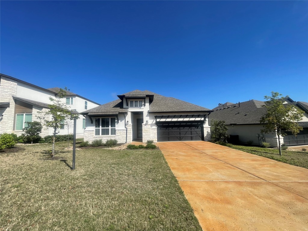 512 Elworth Path Lakeway, TX 78738 - Photo 1 of 28 a front view of a house with a yard