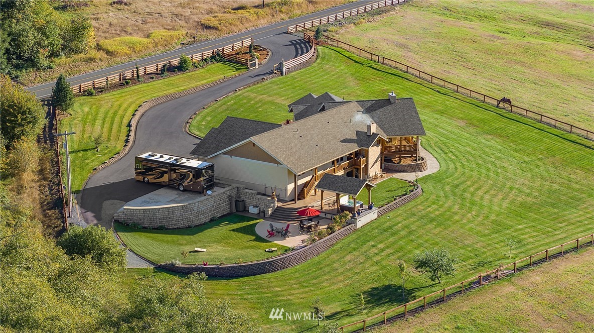 401 Highland Valley Road Morton, WA 98356 - Photo 2 of 39 an aerial view of a house with a garden and lake view