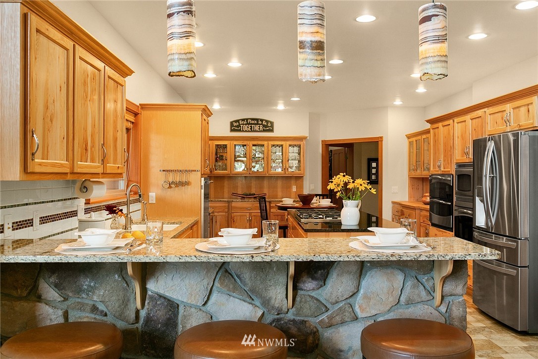 401 Highland Valley Road Morton, WA 98356 - Photo 16 of 39 a kitchen with a table chairs stove and cabinets