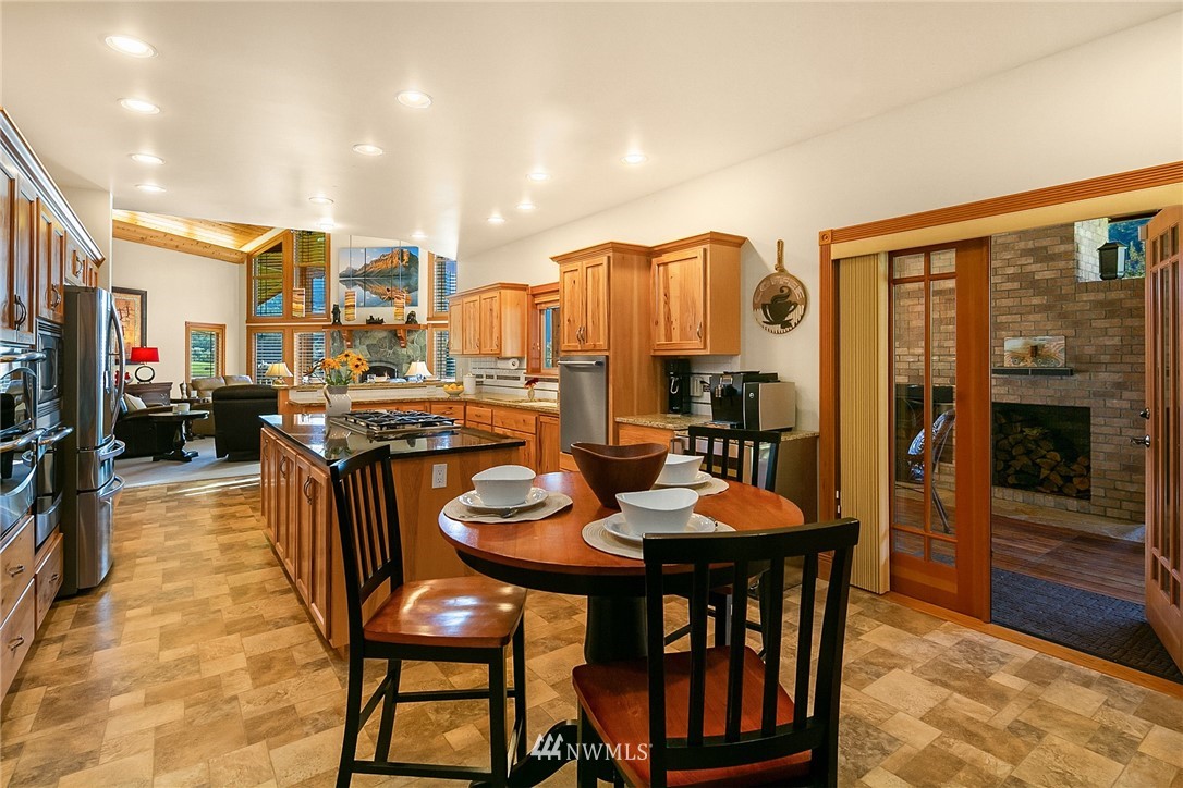 401 Highland Valley Road Morton, WA 98356 - Photo 18 of 39 a view of a dining room with furniture and a kitchen