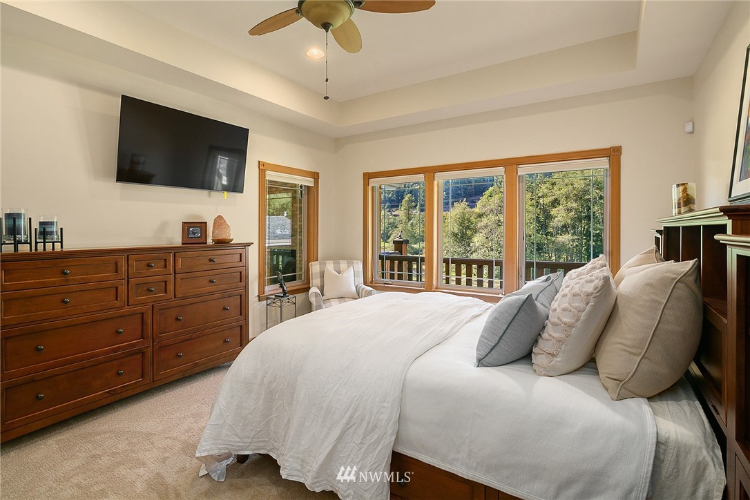 401 Highland Valley Road Morton, WA 98356 - Photo 21 of 39 a bedroom with a large bed and a flat screen tv