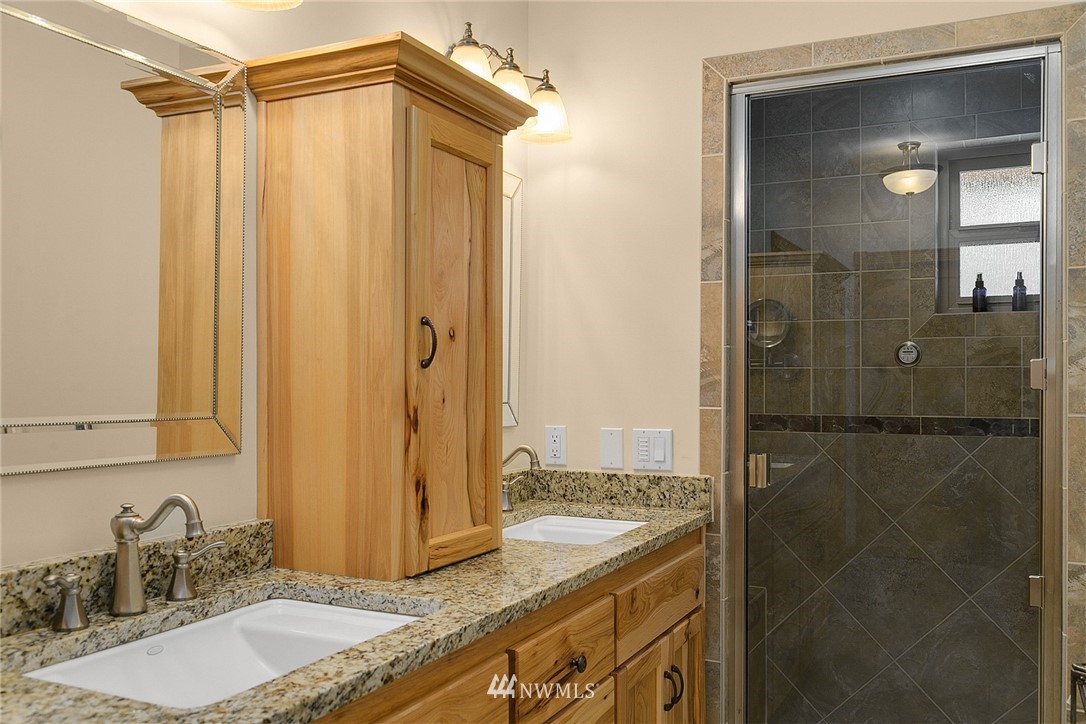 401 Highland Valley Road Morton, WA 98356 - Photo 22 of 39 a bathroom with a granite countertop sink and shower