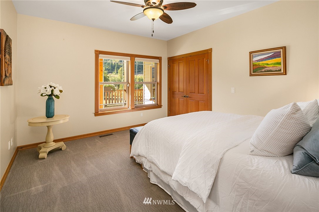 401 Highland Valley Road Morton, WA 98356 - Photo 25 of 39 a bedroom with a bed and a chandelier