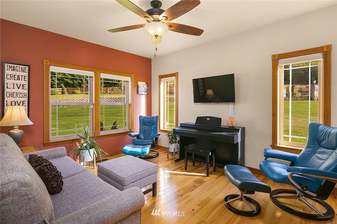 401 Highland Valley Road Morton, WA 98356 - Photo 26 of 39 a living room with furniture a flat screen tv and a large window