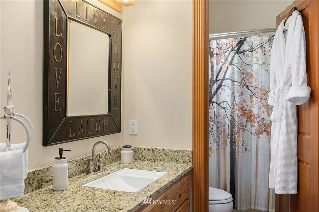 401 Highland Valley Road Morton, WA 98356 - Photo 27 of 39 a bathroom with a granite countertop sink and a mirror