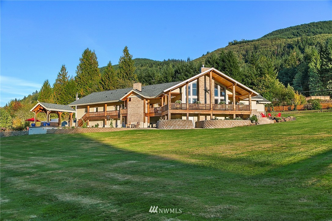 401 Highland Valley Road Morton, WA 98356 - Photo 29 of 39 a front view of a house with a yard table and chairs