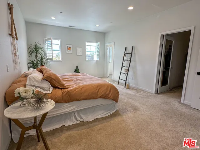 a bedroom with a bed and a table in it