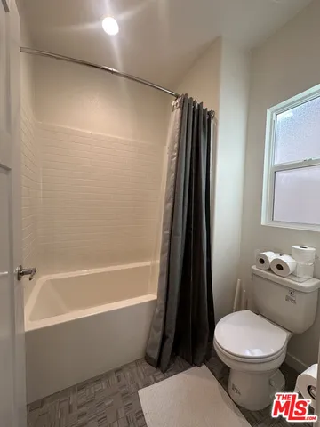 a bathroom with a toilet a sink and a bathtub