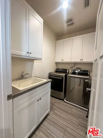 a kitchen with granite countertop white cabinets and stainless steel appliances