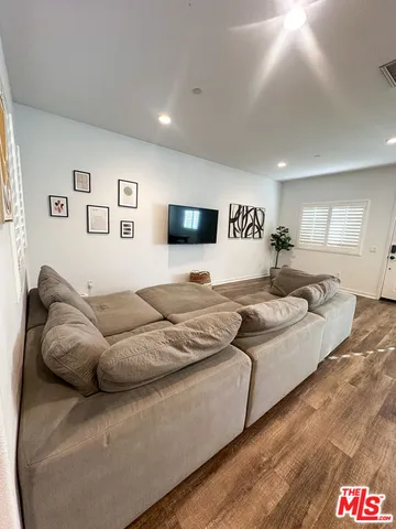 a large bedroom with a bed and a couch