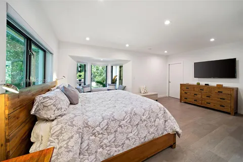 a bedroom with a bed and tv