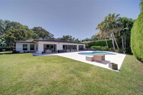 a swimming pool with outdoor seating and yard